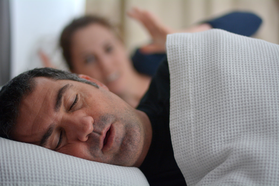 Image of couple with husband suffering from Sleep Apnea